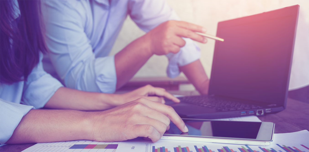 People pointing at a laptop