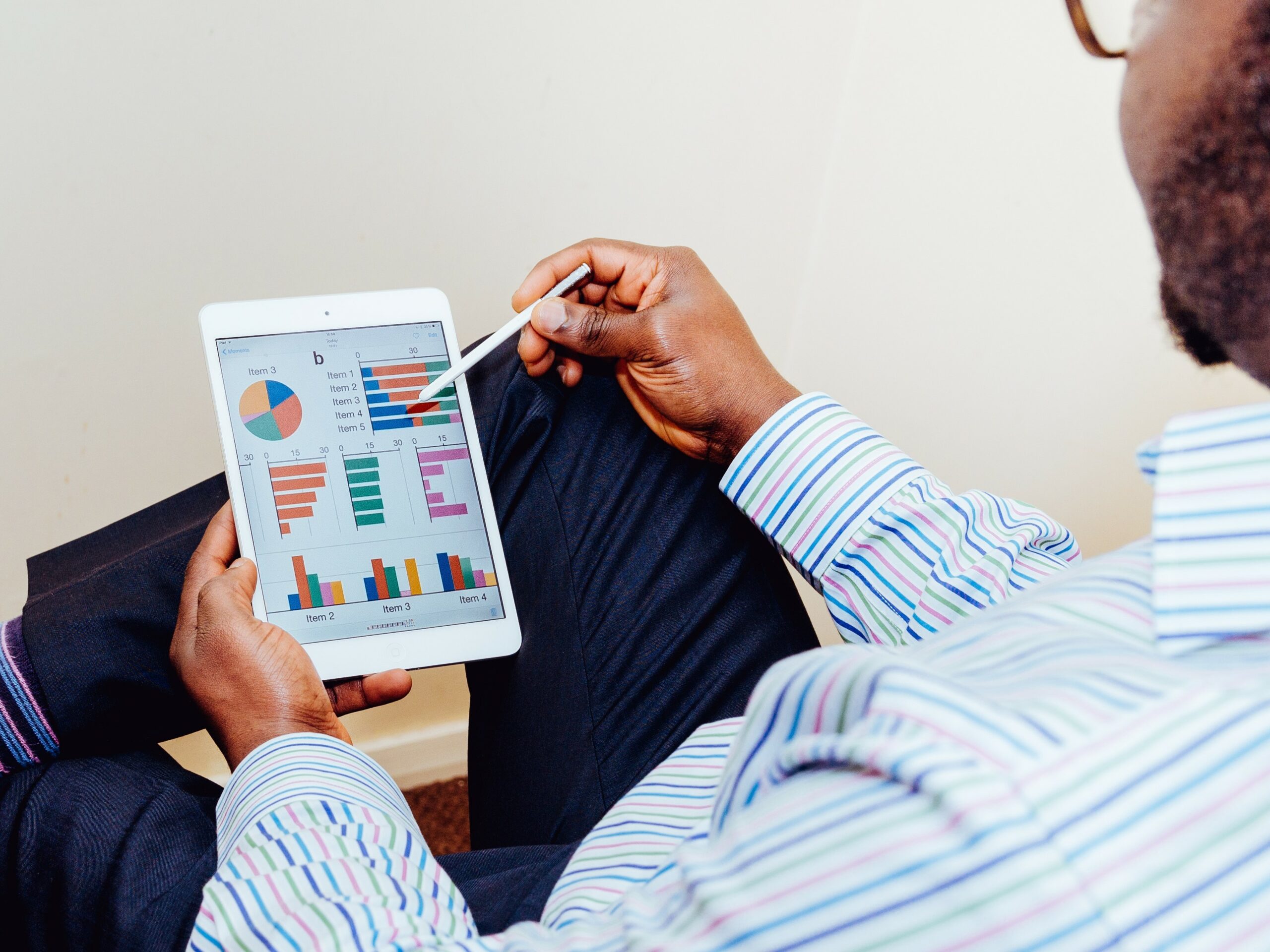 adeolu-eletu-unRkg2jH1j0-unsplash-cropped Man reviewing dashboard on tablet