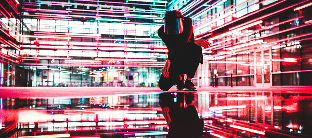 Man stands in neon alleyway