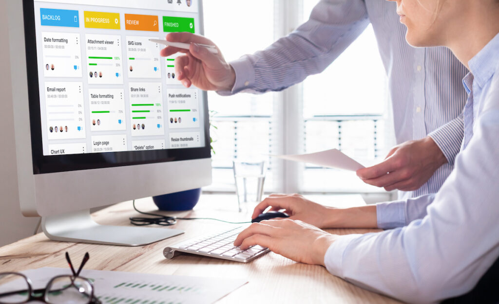 Colleagues working on agile product development board with scrum or kanban framework, lean methodology, iterative or incremental organization project management strategy for startup or software design