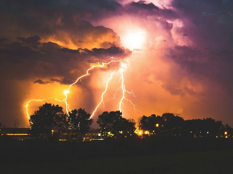 lightning-storm lightning storm over trees at night
