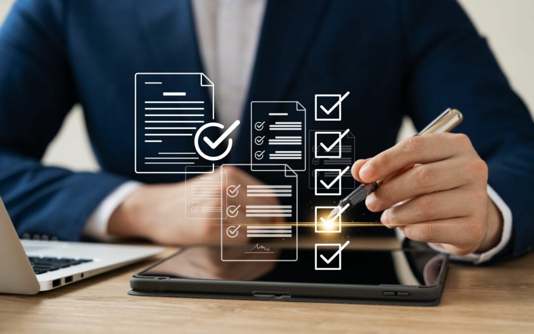 checklist graphics in front of man in suit sitting at a desk with a laptop and tablet