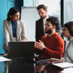 4-person team meeting in a modern office conference room