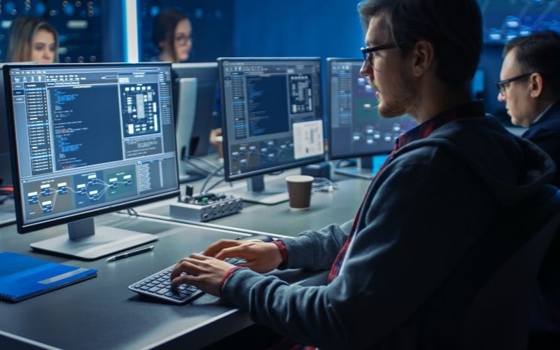 people working at computers in operations control room
