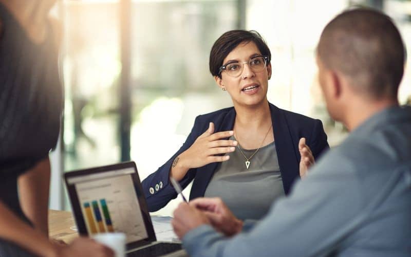 woman explaining to man in office setting