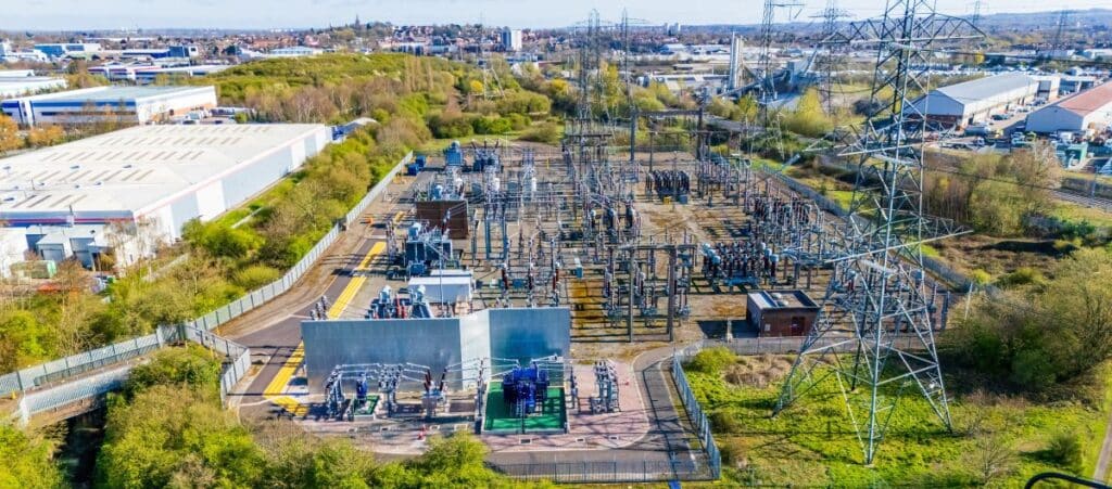 Aerial view of a modern electrical substation with transformers and insulators. Insulators, transmission line and other electrical distribution components in an electrical substation