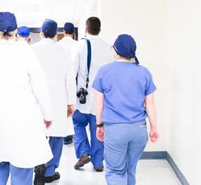 healthcare-staff-small hospital staffers walking down a corridor