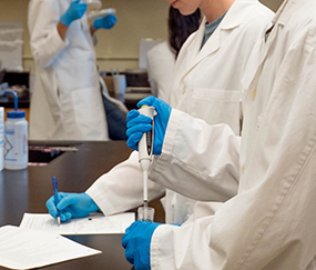 process-improvement-healthcare_285 scientists in a laboratory testing a fluid